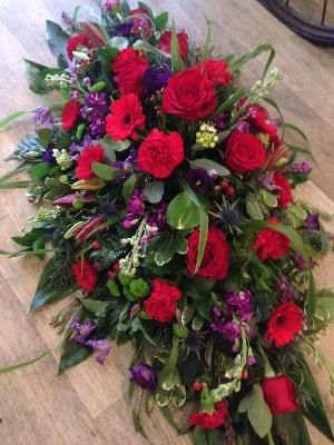 Red, blues and purple casket spray