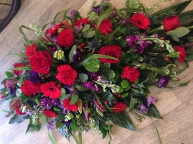 Red, blues and purple casket spray