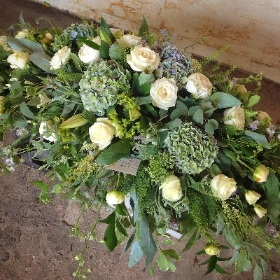 Seasonal Pale blue, white and lime casket spray.